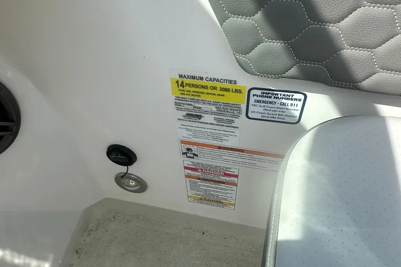 Slide: The Image of 2023 Sea Ray SDX 250 Outboard capacity label, seating, and safety information. - 25