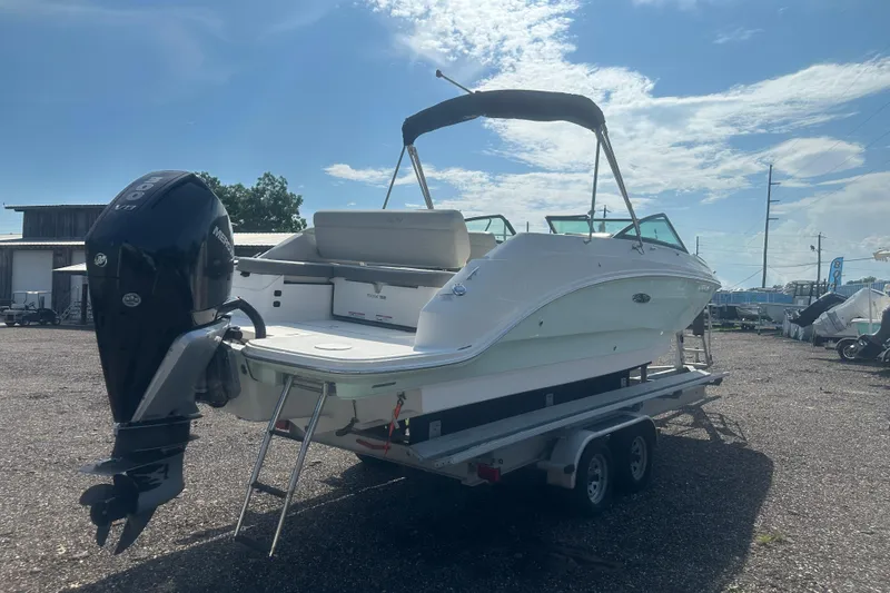 Slide: The Image of 2023 Sea Ray SDX 250 Outboard boat on trailer under clear sky. - 5
