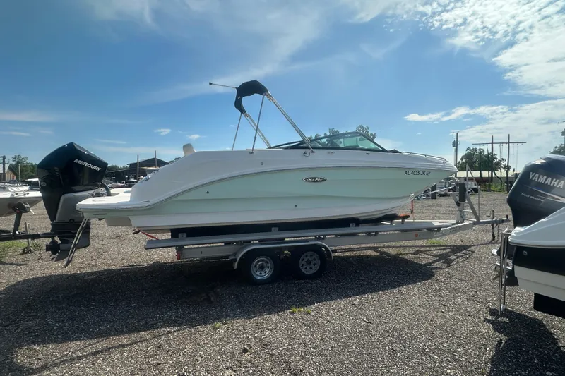 Slide: The Image of 2023 Sea Ray SDX 250 Outboard boat on trailer, parked outdoors. - 7