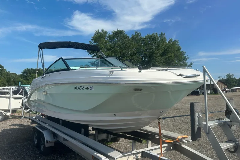 Slide: The Image of 2023 Sea Ray SDX 250 Outboard boat on trailer, sunny day, trees in background. - 8