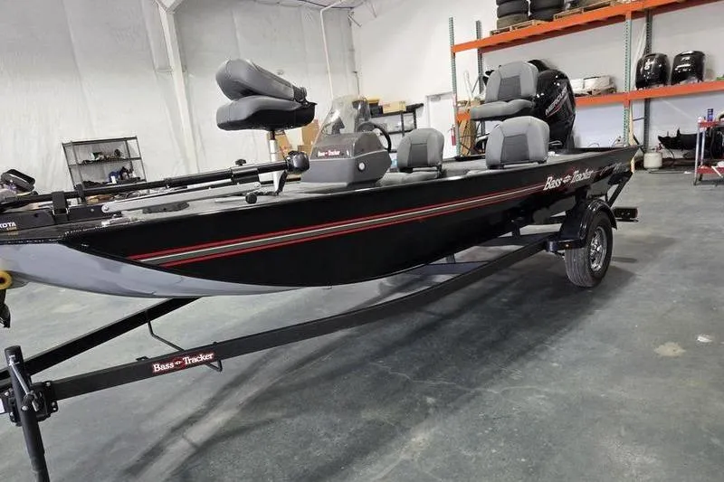 The Image of 2026 Tracker BT CLASSIC XL fishing boat in a showroom, featuring sleek design and comfortable seating. - 1