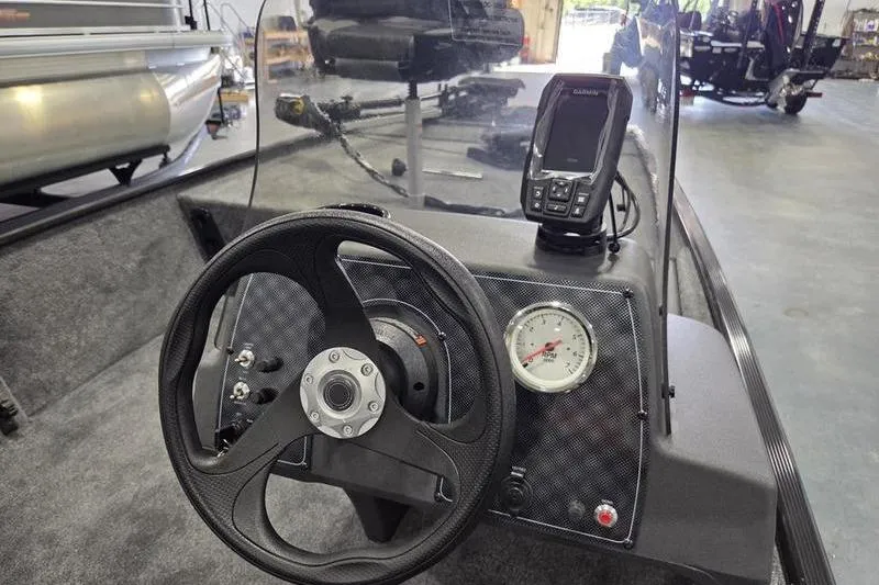 Slide: The Image of 2026 Tracker BT CLASSIC XL boat dashboard with steering wheel and navigation system. - 10