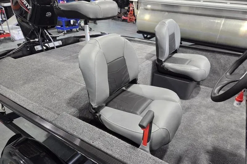 Slide: The Image of 2026 Tracker BT CLASSIC XL boat interior with gray seating and steering wheel. - 12