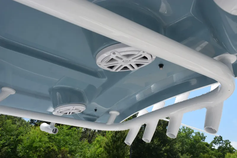 Slide: The Image of 2026 Sea Hunt Ultra 219 boat speakers and rod holders under blue canopy. - 11