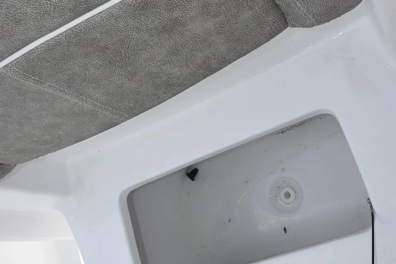 Slide: The Image of Interior view of 2026 Sea Hunt Ultra 219 boat, featuring storage compartment and seating. - 16
