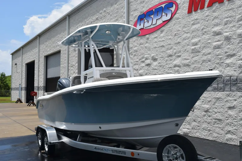 Slide: The Image of 2026 Sea Hunt Ultra 219 boat on trailer outside GSPS Marine building. - 2