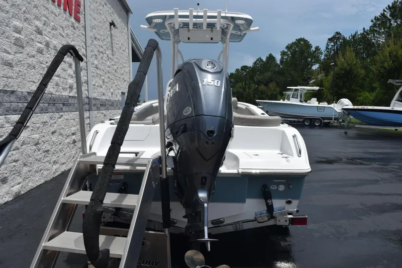 Slide: The Image of 2026 Sea Hunt Ultra 219 boat with 150 HP engine, parked outdoors. - 5