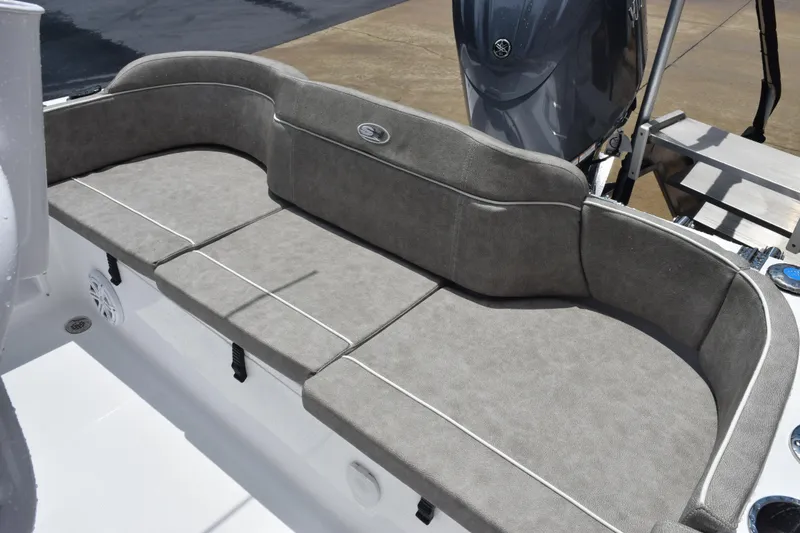 Slide: The Image of 2026 Sea Hunt Ultra 219 boat with cushioned seating and outboard motor. - 8