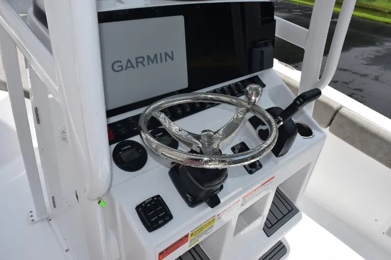 Slide: The Image of 2026 Sea Hunt Ultra 219 boat console with Garmin navigation system and steering wheel. - 9
