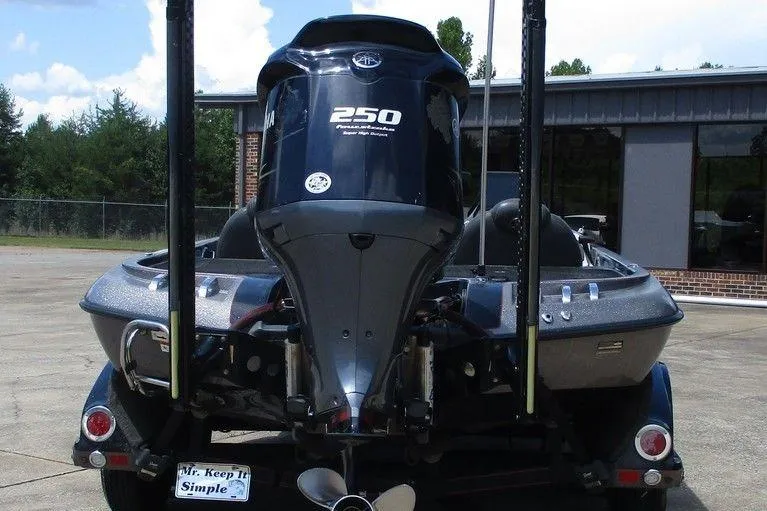 Slide: The Image of 2010 Ranger Z520 boat with powerful 250 HP engine, parked outdoors. - 3
