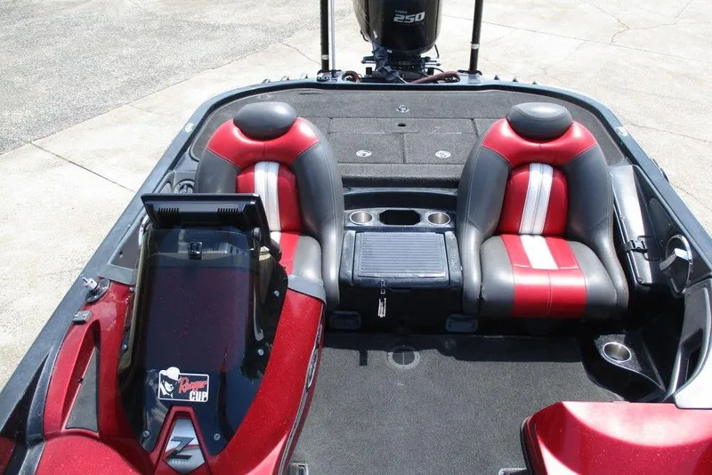 Slide: The Image of 2010 Ranger Z520 boat interior with red and black seats, steering console, and storage compartments. - 7