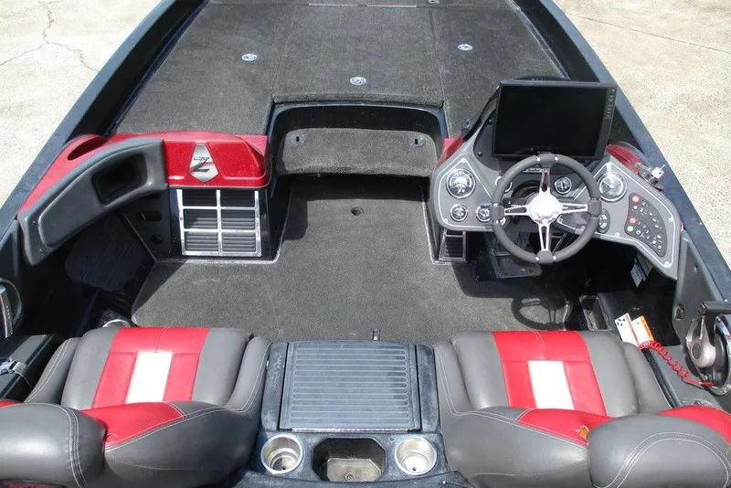 Slide: The Image of 2010 Ranger Z520 boat interior with red and black seats, steering wheel, and control panel. - 9