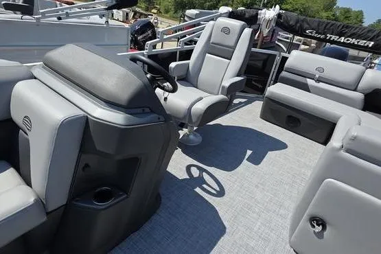Slide: The Image of 2026 Sun Tracker PB 20 DLX pontoon boat interior with gray seating and steering console. - 18