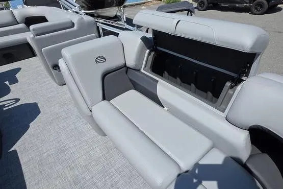 Slide: The Image of 2026 Sun Tracker PB 20 DLX pontoon boat with open storage compartment and gray seating. - 20