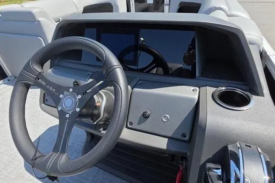 Slide: The Image of Steering console of 2026 Sun Tracker PB 20 DLX pontoon boat, featuring modern controls. - 22