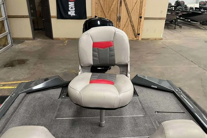 Slide: The Image of 2026 Tracker Pro Team™ 190 TX boat seat in showroom, featuring gray and red upholstery. - 7