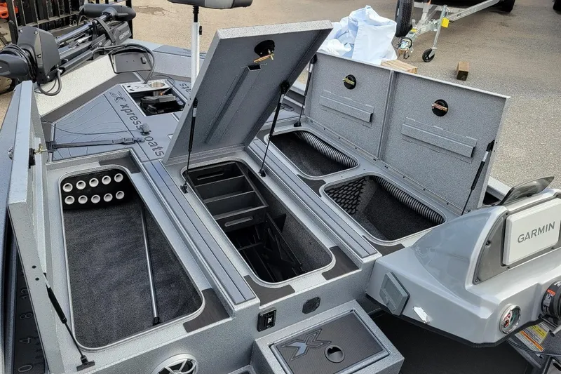 Slide: The Image of 2026 Xpress X19 Pro Bass boat interior with storage compartments and Garmin equipment. - 5