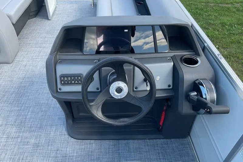 Slide: The Image of Steering console of 2026 Sun Tracker PB 18 DLX pontoon boat, featuring modern controls. - 3