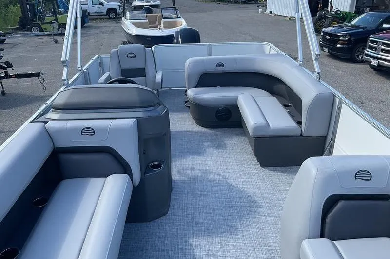 Slide: The Image of 2026 Sun Tracker PB 18 DLX pontoon boat interior with gray seating and spacious layout. - 7
