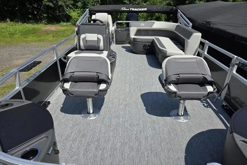 Slide: The Image of 2026 Sun Tracker BB 18 DLX pontoon boat interior with gray seating and carpet. - 10