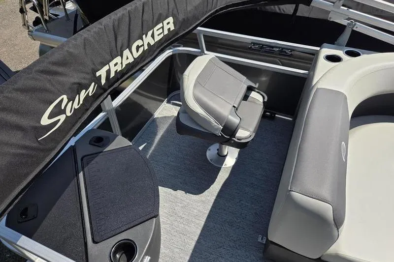 Slide: The Image of 2026 Sun Tracker BB 18 DLX boat interior with seating and storage. - 12