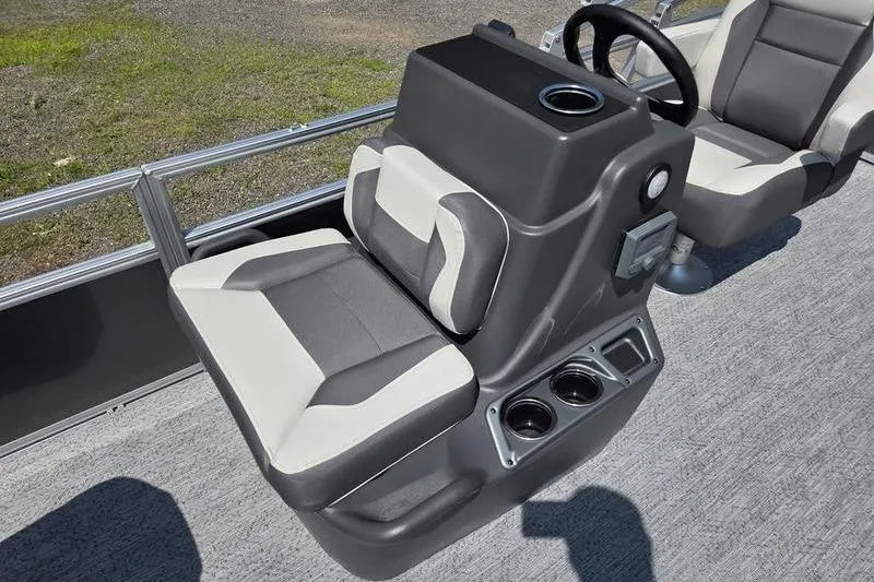 Slide: The Image of 2026 Sun Tracker BB 18 DLX boat interior with dual-tone seating and steering console. - 13