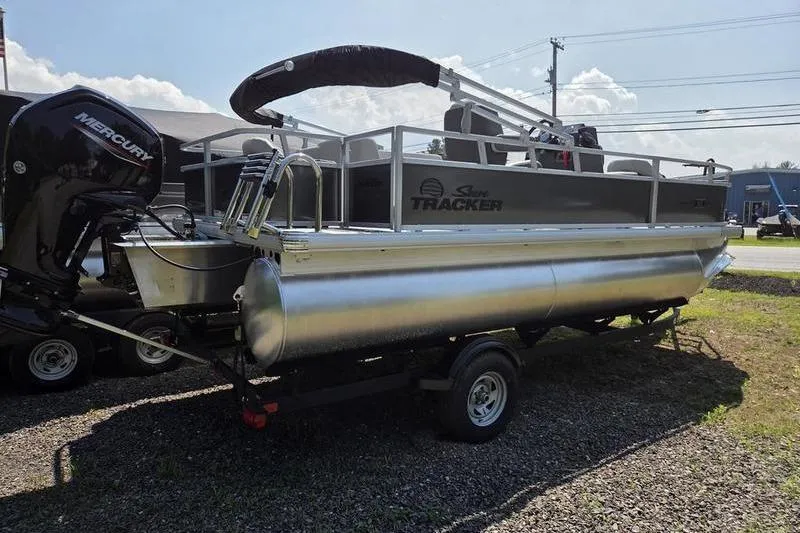 Slide: The Image of 2026 Sun Tracker BB 18 DLX pontoon boat on trailer, featuring Mercury outboard motor. - 6