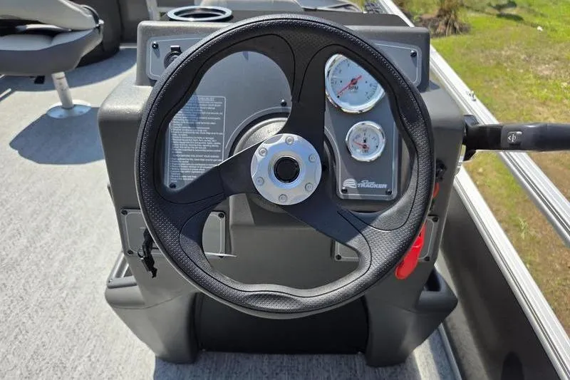 Slide: The Image of Steering console of 2026 Sun Tracker BB 18 DLX boat with gauges and controls. - 7