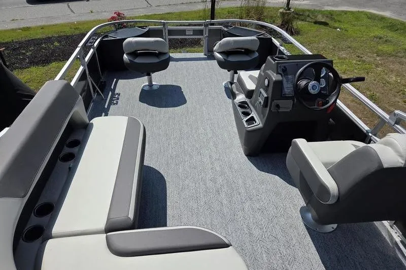 Slide: The Image of 2026 Sun Tracker BB 18 DLX pontoon boat interior with seating and steering console. - 8