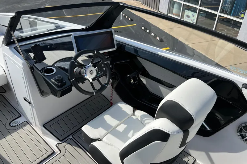 Slide: The Image of 2024 Yamaha Boats 222SE cockpit with steering wheel and touchscreen display. - 15