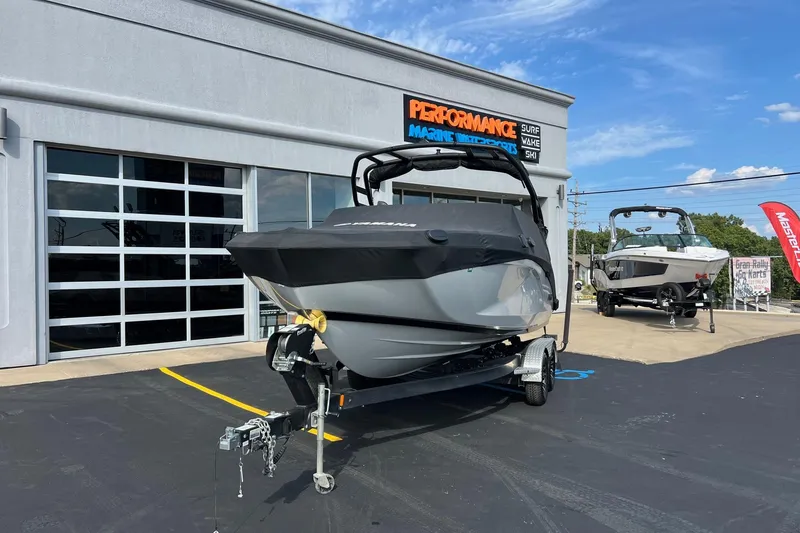 Slide: The Image of 2024 Yamaha Boats 222SE displayed at a marine dealership under a clear blue sky. - 16