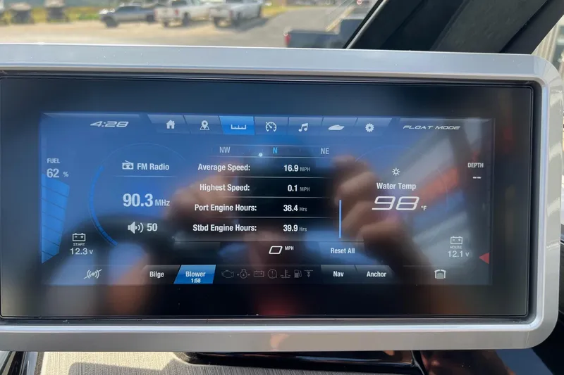Slide: The Image of 2024 Yamaha Boats 222SE dashboard displaying FM radio, speed, and water temperature. - 7