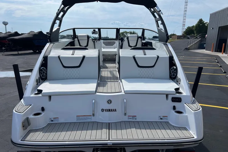Slide: The Image of 2024 Yamaha Boats 222SE, rear view, showcasing sleek design and spacious seating. - 9