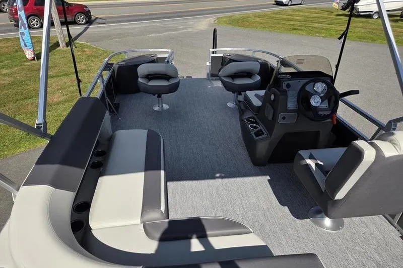 Slide: The Image of 2026 Sun Tracker BB 18 DLX pontoon boat interior with seating and steering console. - 11