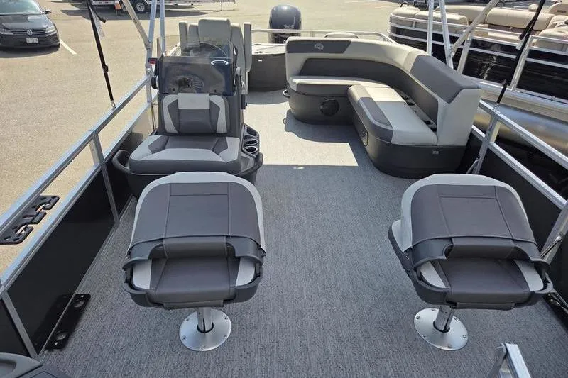 Slide: The Image of 2026 Sun Tracker BB 18 DLX pontoon boat interior with seating and helm. - 12