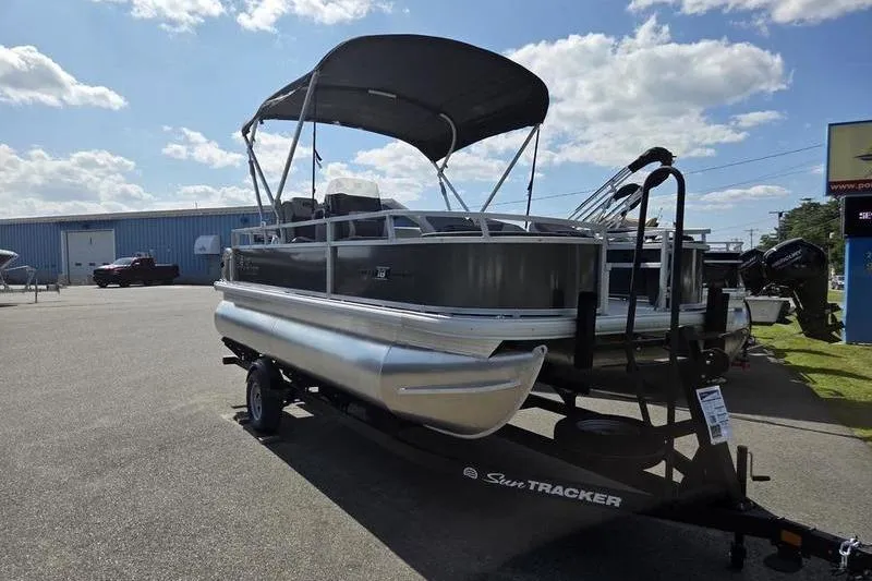 Slide: The Image of 2026 Sun Tracker BB 18 DLX pontoon boat on trailer under sunny sky. - 5