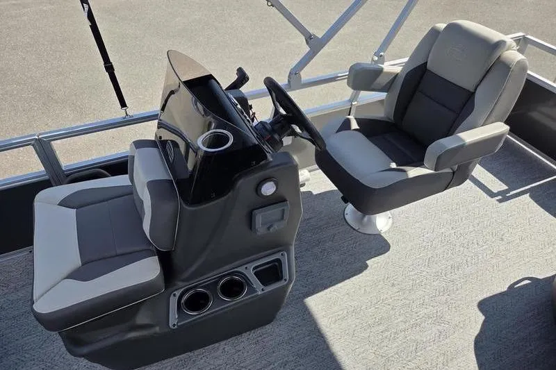 Slide: The Image of 2026 Sun Tracker BB 18 DLX boat interior with steering console and seating. - 7