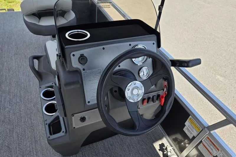 Slide: The Image of 2026 Sun Tracker BB 18 DLX boat dashboard with steering wheel and cup holders. - 8