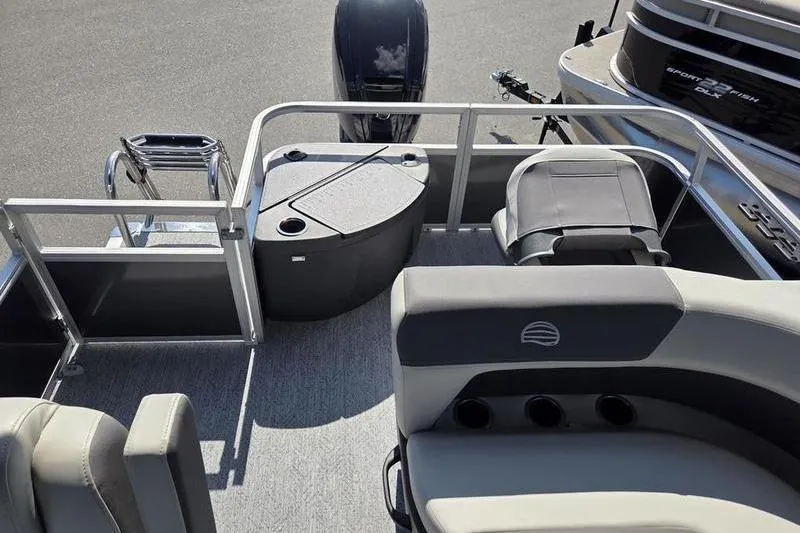 Slide: The Image of 2026 Sun Tracker BB 18 DLX pontoon boat interior with seating and storage compartments. - 9