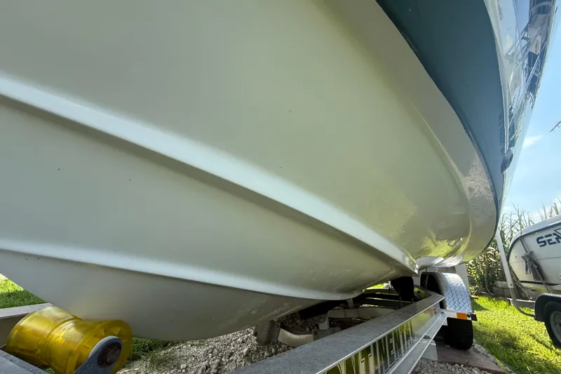 Slide: The Image of 2020 Striper 220 Center Console boat on trailer, close-up view of hull. - 1