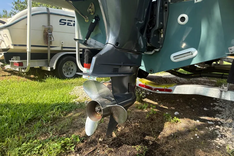 Slide: The Image of 2020 Striper 220 Center Console boat with visible outboard motor and trailer. - 12