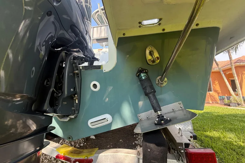 Slide: The Image of 2020 Striper 220 Center Console boat on trailer, showing engine and hull details. - 14