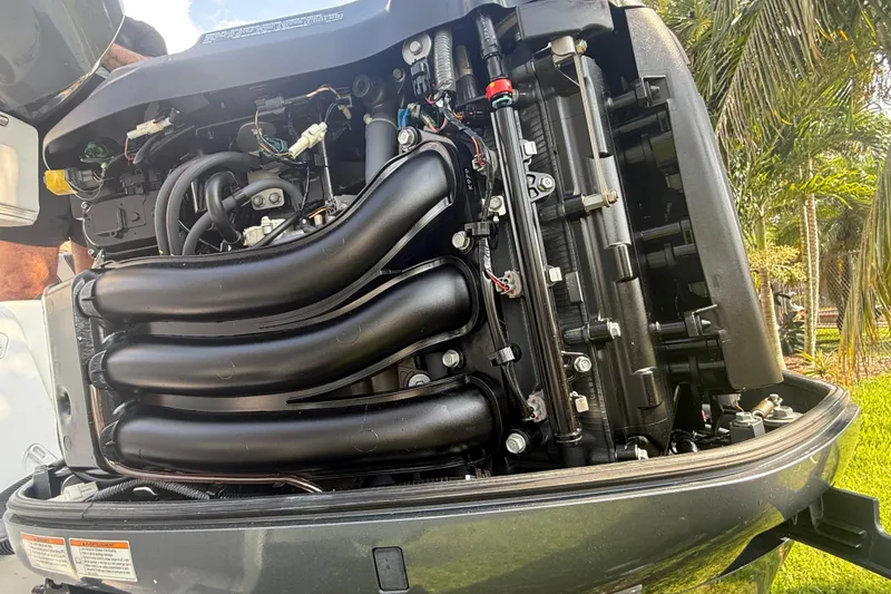 Slide: The Image of 2020 Striper 220 Center Console boat engine close-up with visible components. - 18
