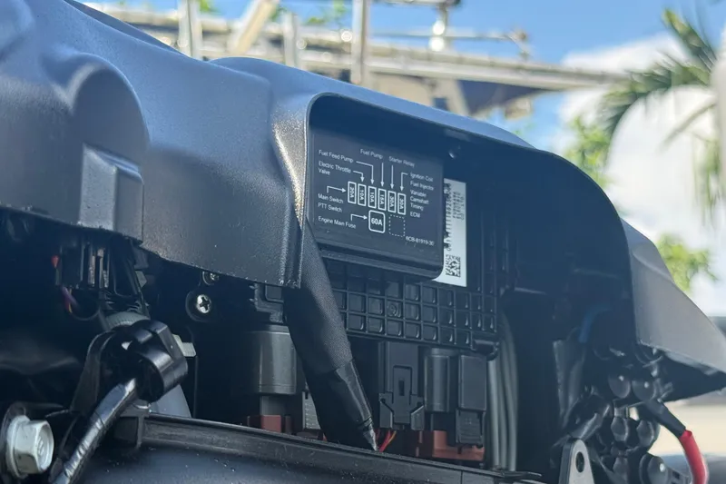 Slide: The Image of Close-up of a 2020 Striper 220 Center Console engine compartment with visible wiring and components. - 20