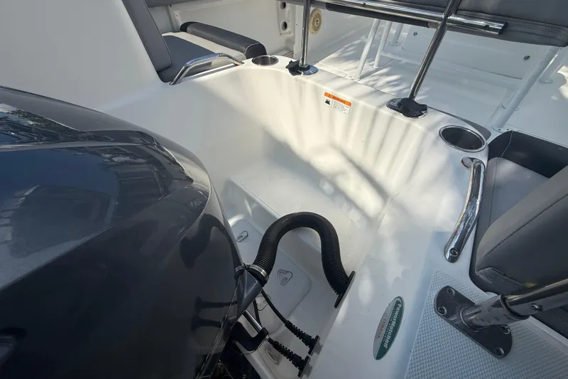 Slide: The Image of 2020 Striper 220 Center Console boat interior with seating and engine details. - 21