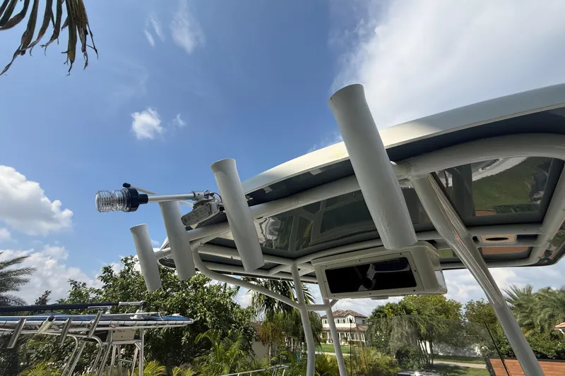Slide: The Image of 2020 Striper 220 Center Console boat with rod holders and clear blue sky background. - 28