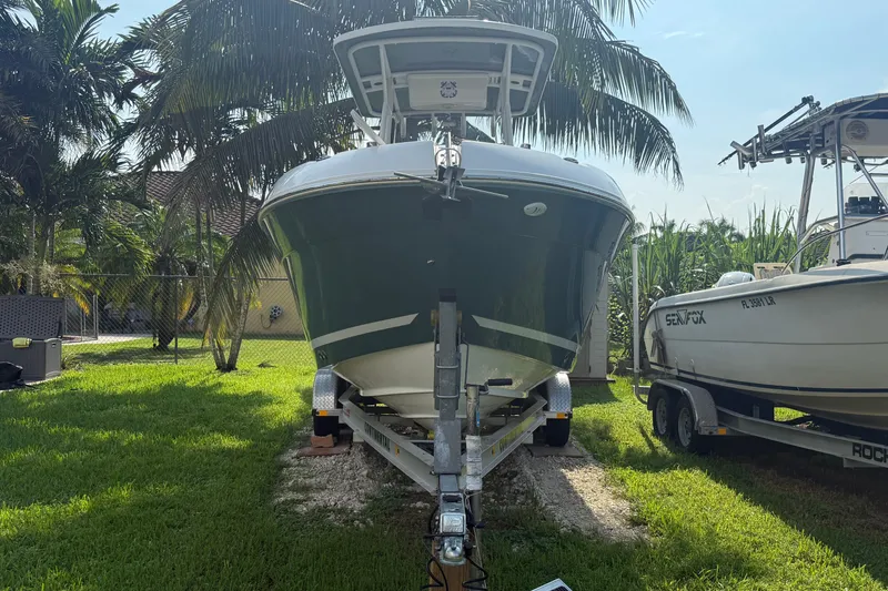 Slide: The Image of 2020 Striper 220 Center Console boat on trailer, surrounded by palm trees. - 3