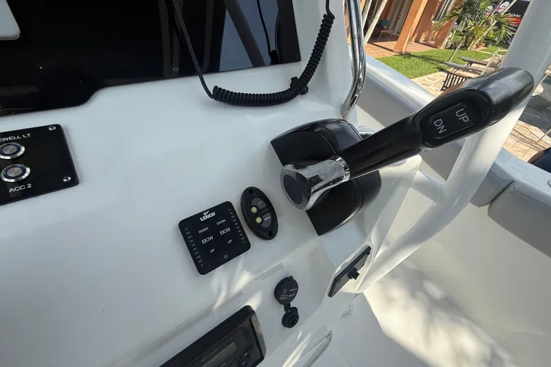 Slide: The Image of Control panel of 2020 Striper 220 Center Console boat with throttle and switches. - 33