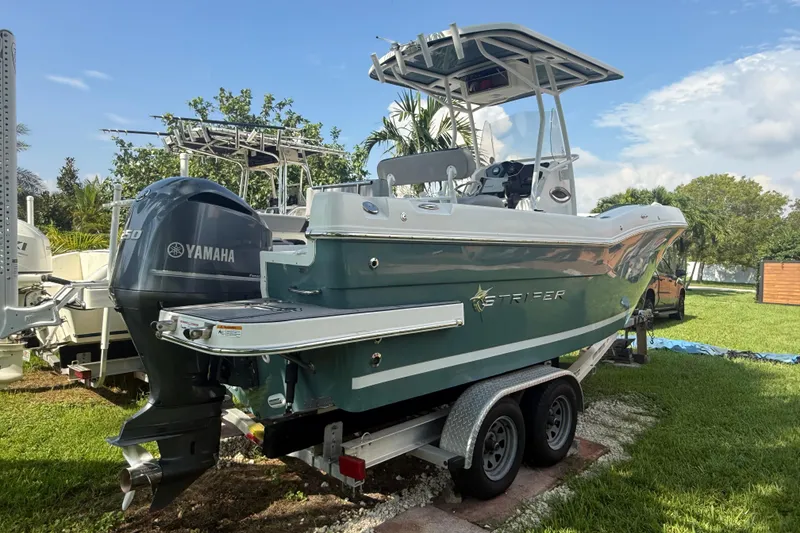 Slide: The Image of 2020 Striper 220 Center Console boat with Yamaha engine on trailer, parked on grass. - 4