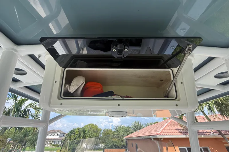 Slide: The Image of Open storage compartment on 2020 Striper 220 Center Console boat, with items inside. - 40